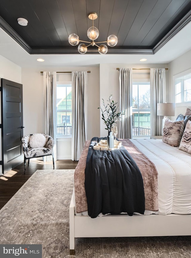 bedroom with dark hardwood / wood-style flooring, wooden ceiling, ornamental molding, and a raised ceiling