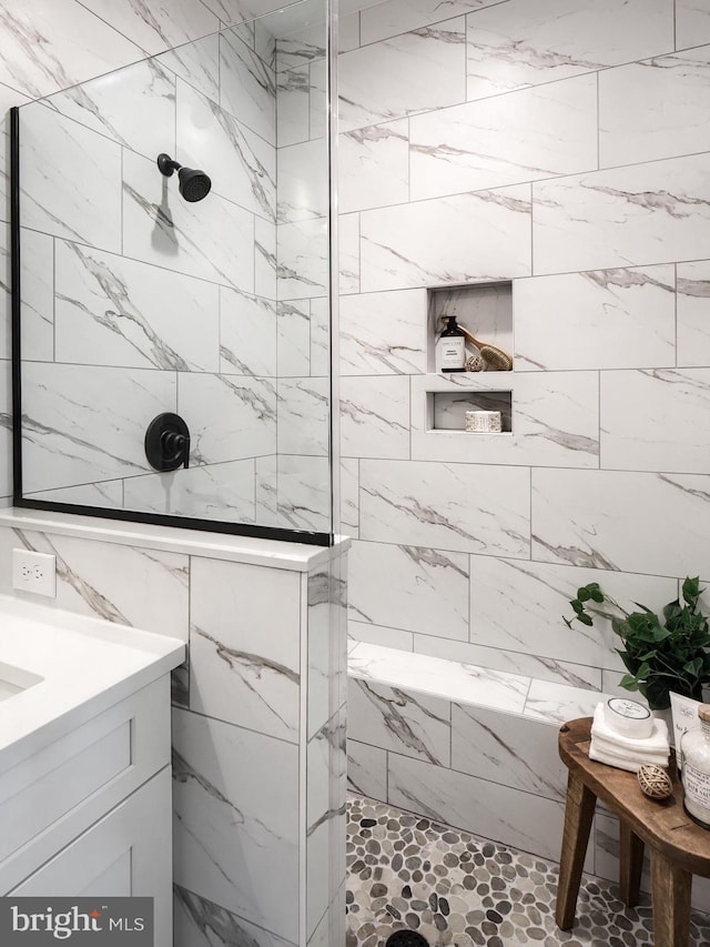 bathroom featuring vanity and a tile shower