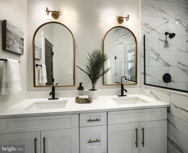 bathroom featuring tile walls, vanity, and tiled shower