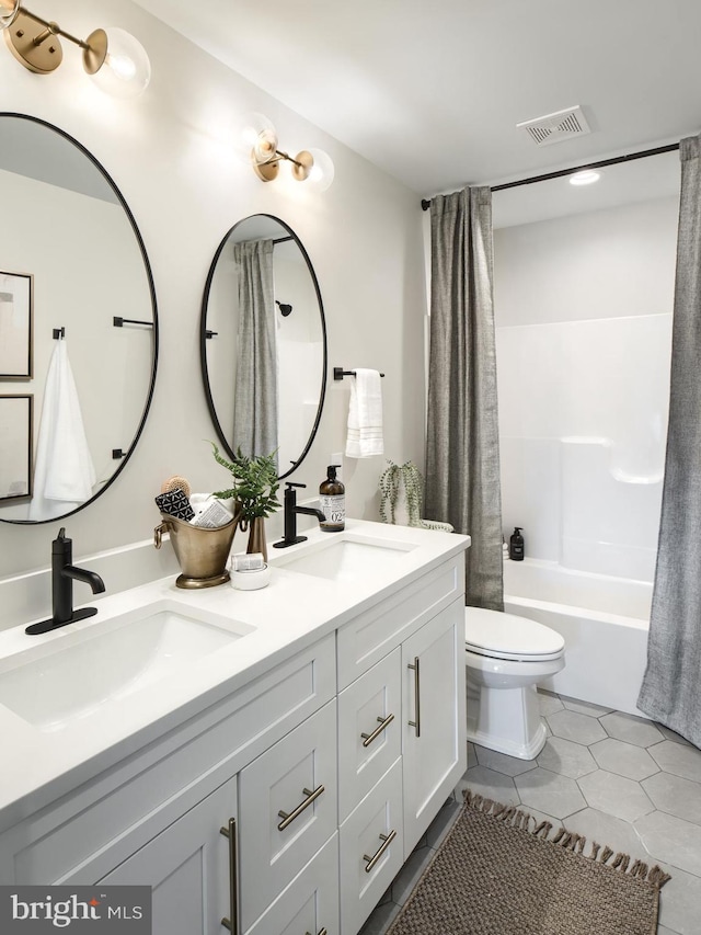 full bathroom featuring vanity, tile patterned floors, toilet, and shower / tub combo