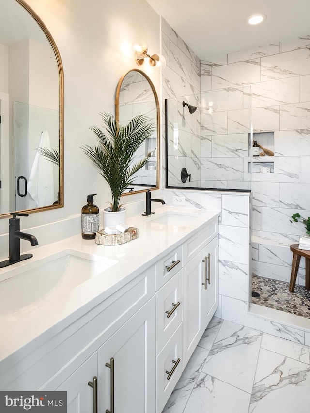 bathroom with vanity and a tile shower