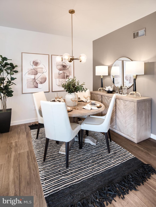 dining space with wood-type flooring