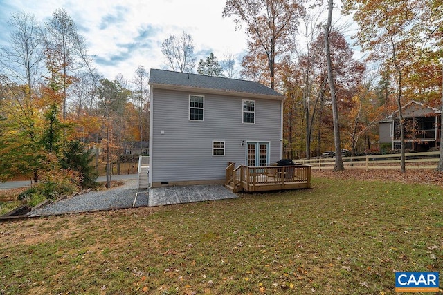 rear view of house featuring a deck, a patio, and a yard