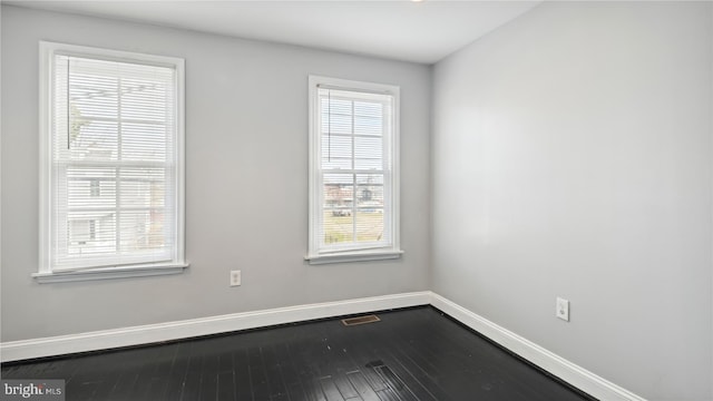 unfurnished room with plenty of natural light and hardwood / wood-style flooring