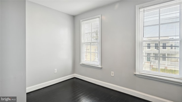 spare room with wood-type flooring