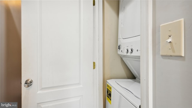 laundry area featuring stacked washer / drying machine