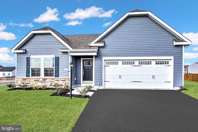 view of front of home with a garage and a front lawn