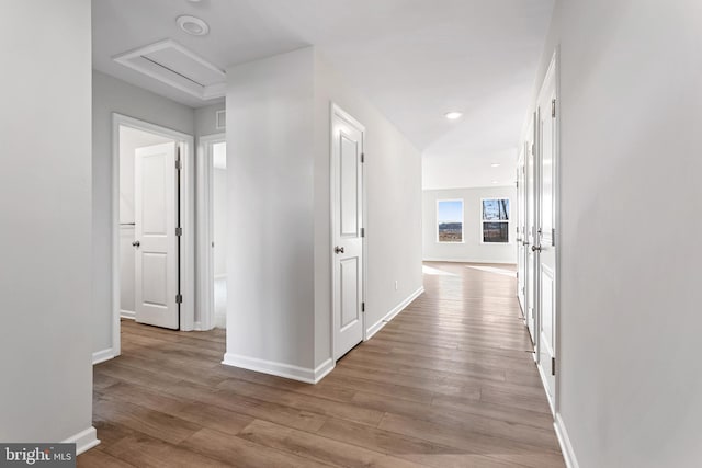 hallway with light hardwood / wood-style floors