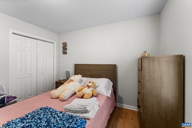 bedroom with hardwood / wood-style floors and a closet