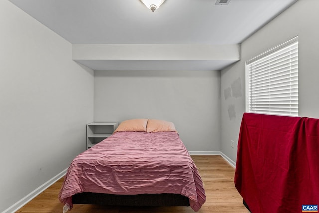 bedroom with hardwood / wood-style floors