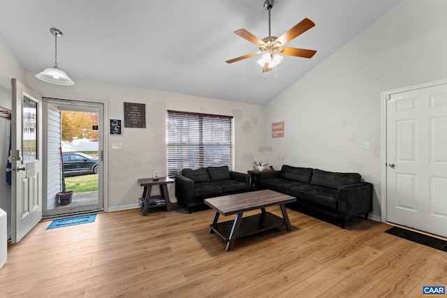 living room with high vaulted ceiling, ceiling fan, and light hardwood / wood-style floors