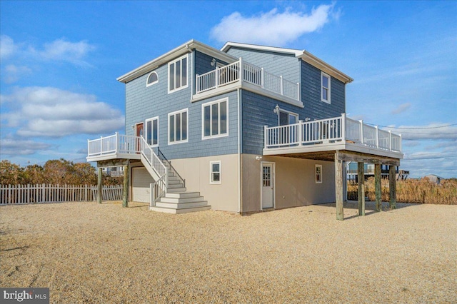 rear view of house with a balcony and a wooden deck