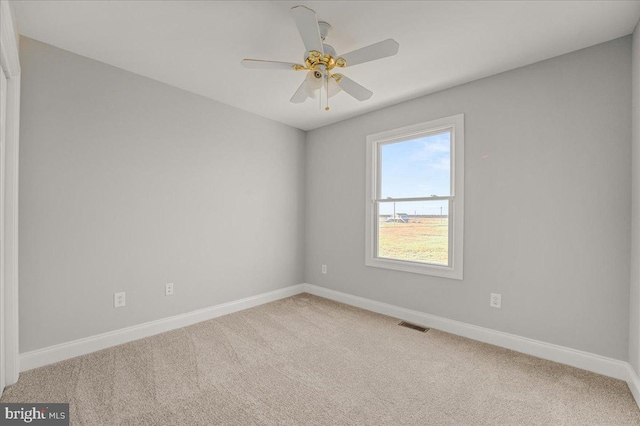 spare room featuring carpet flooring and ceiling fan