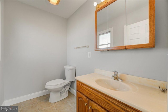 bathroom featuring tile patterned floors, vanity, and toilet