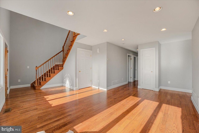 unfurnished living room with hardwood / wood-style flooring