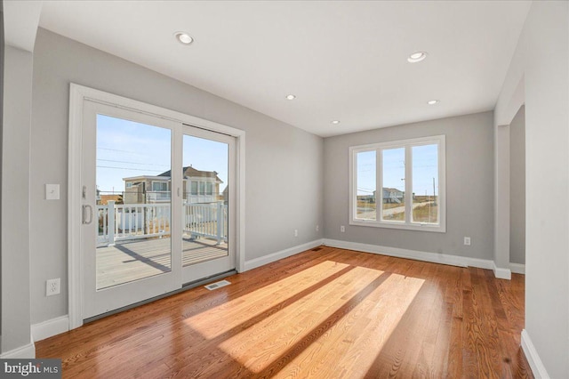 unfurnished room with wood-type flooring