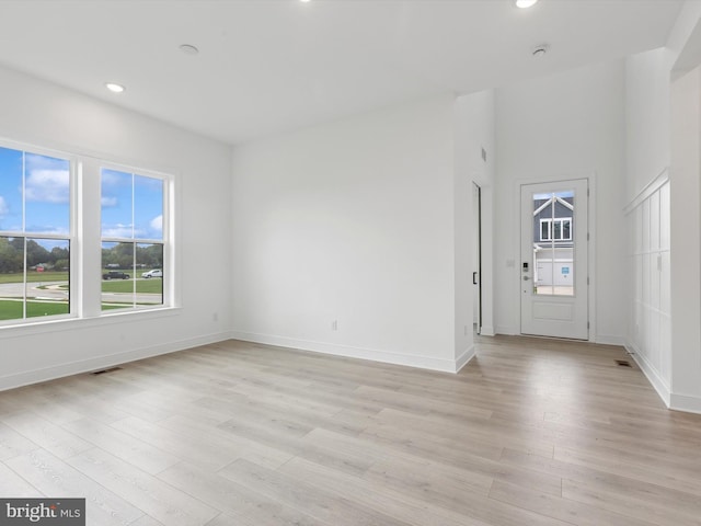 spare room featuring light hardwood / wood-style floors