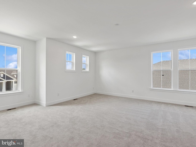 carpeted spare room with plenty of natural light