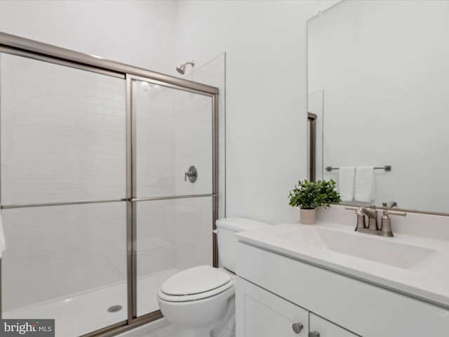 bathroom with vanity, toilet, and walk in shower