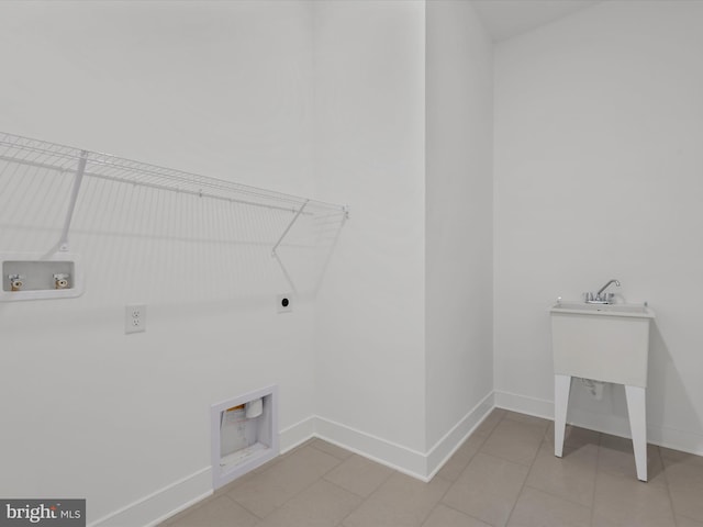 laundry area with hookup for a washing machine, electric dryer hookup, and light tile patterned flooring