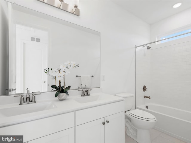 full bathroom featuring vanity, tiled shower / bath combo, and toilet