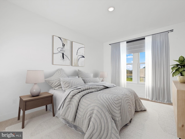 bedroom featuring light carpet