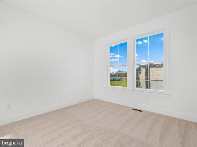 spare room with light carpet