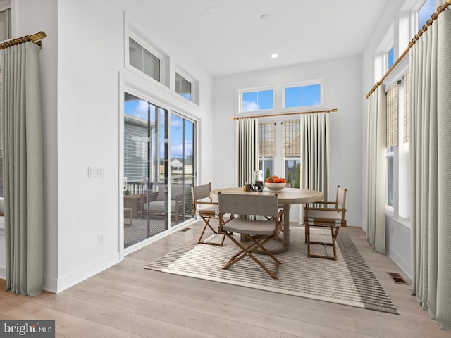 dining area featuring plenty of natural light and light wood-type flooring