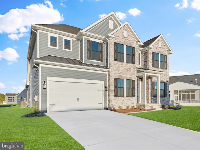 craftsman house with a front yard and a garage