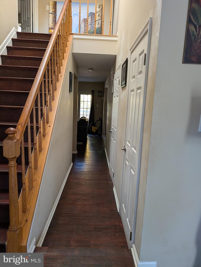 hall with dark hardwood / wood-style flooring