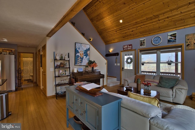 living room featuring high vaulted ceiling and light hardwood / wood-style flooring