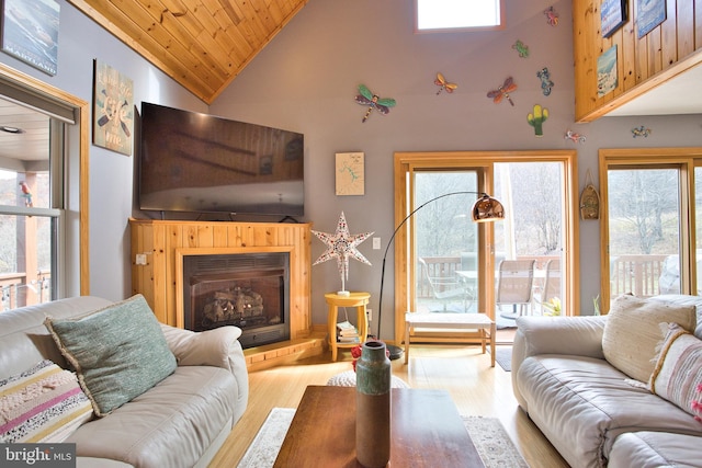 living room with high vaulted ceiling, wooden ceiling, and light hardwood / wood-style flooring