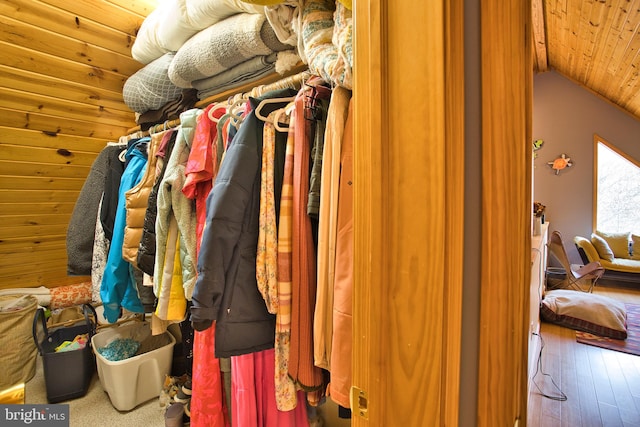 walk in closet featuring hardwood / wood-style floors and vaulted ceiling