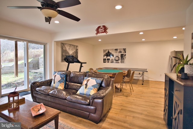 living room featuring light wood-type flooring and ceiling fan