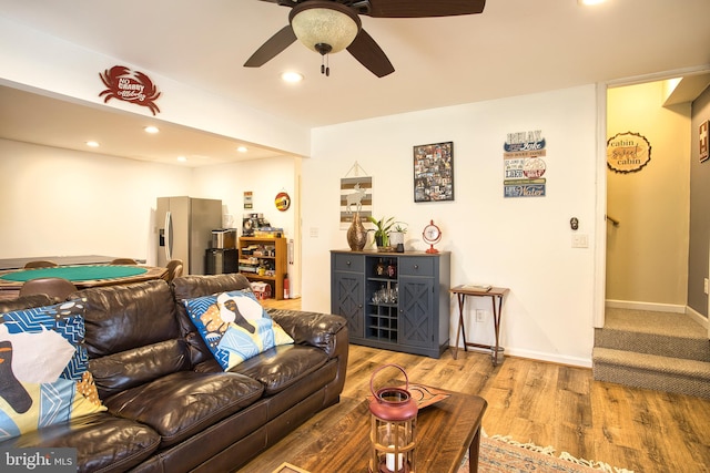 living room with hardwood / wood-style flooring and ceiling fan