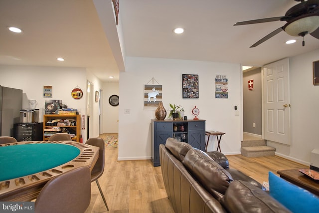 living room featuring light hardwood / wood-style floors and ceiling fan