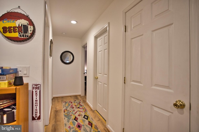 hall with light hardwood / wood-style flooring