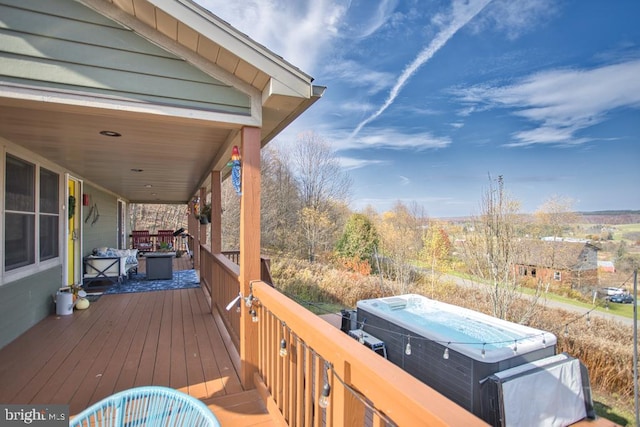 deck featuring a hot tub