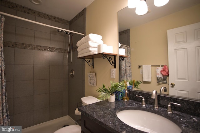 bathroom with toilet, vanity, and a shower with shower curtain