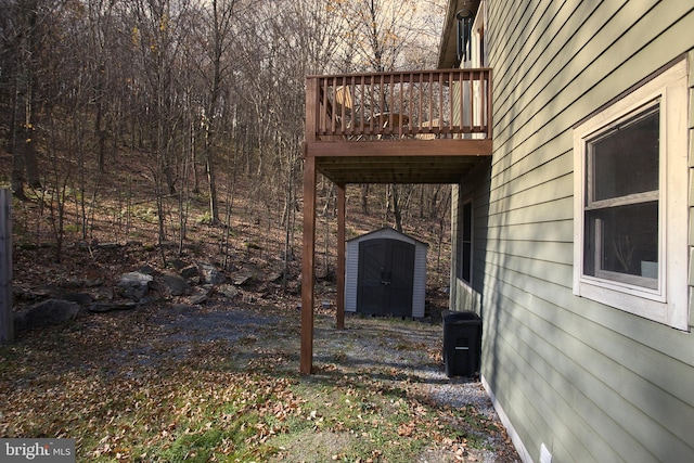 view of yard featuring a deck and a shed