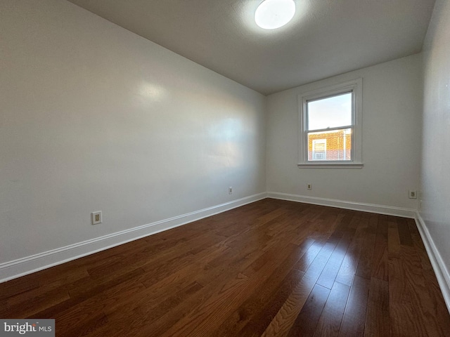 empty room featuring dark hardwood / wood-style floors