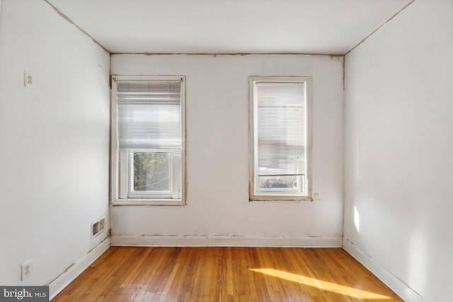 unfurnished room with wood-type flooring