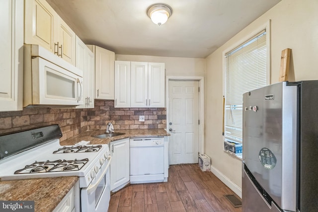 kitchen with dark wood-type flooring, white appliances, sink, and a wealth of natural light