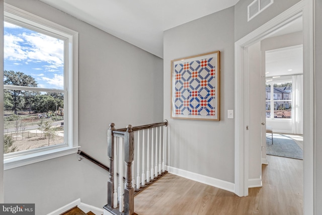 stairs featuring hardwood / wood-style floors