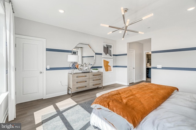 bedroom featuring a notable chandelier and dark hardwood / wood-style floors