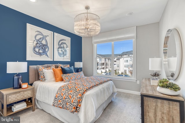 bedroom featuring an inviting chandelier and carpet floors