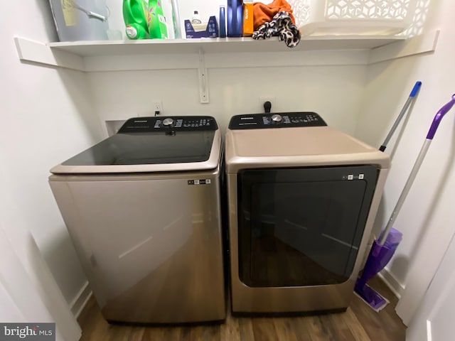 clothes washing area with wood-type flooring and washing machine and clothes dryer