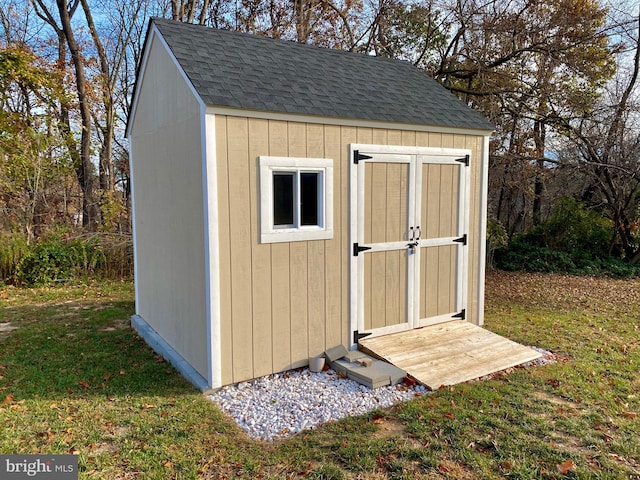 view of outbuilding featuring a lawn