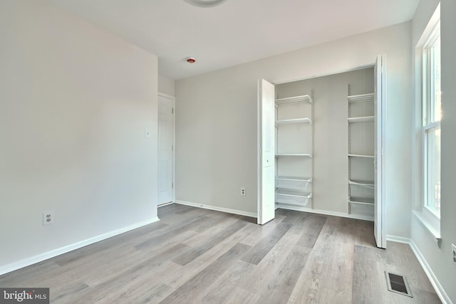 unfurnished bedroom with light wood-type flooring