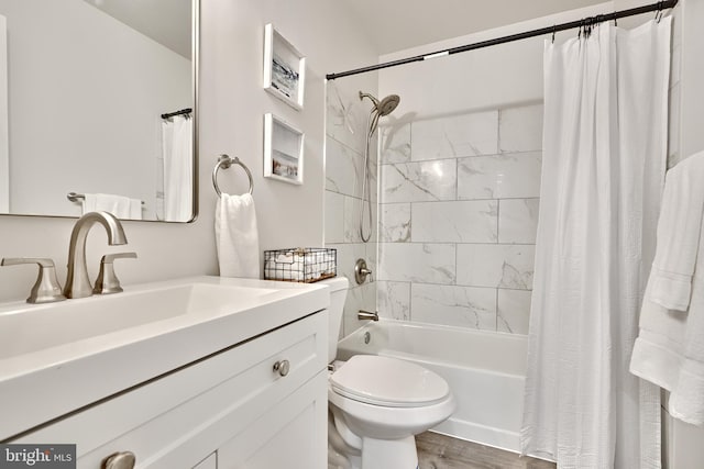 full bathroom with wood-type flooring, vanity, toilet, and shower / bathtub combination with curtain